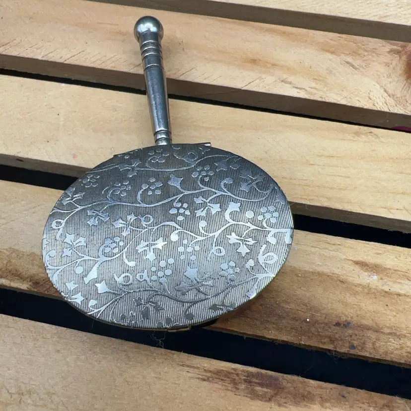 A vintage 1900-1940s silver-plated miniature silent butler with an engraved floral lid.