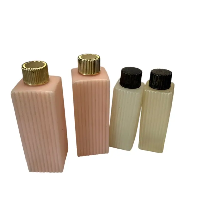 4 Piece (1950’s) Set Of 3 Pink With Gold Lid 4 3/4” Tall Set Of 2 Clear/White With Black Lid 4” Tall Plastic Travel Bottles
