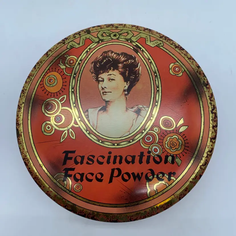 Vintage "Fascination Face Powder" tin with a woman's portrait.