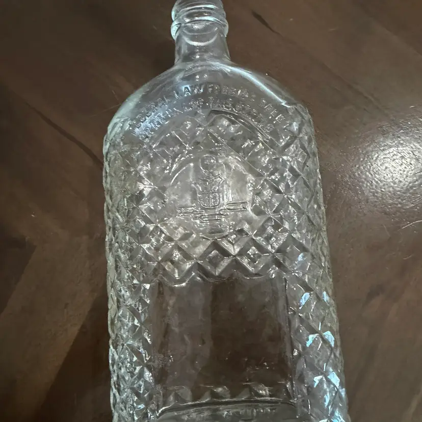 Clear glass Continental Distilling Corp. whisky bottle with diamond pattern.