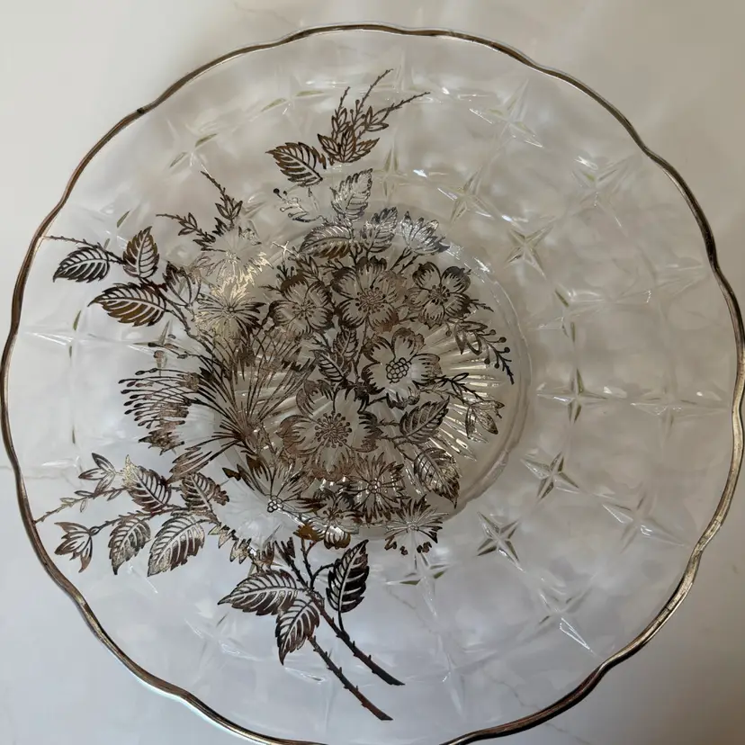 Glass serving platter with silver overlay floral design and scalloped edge. 11”