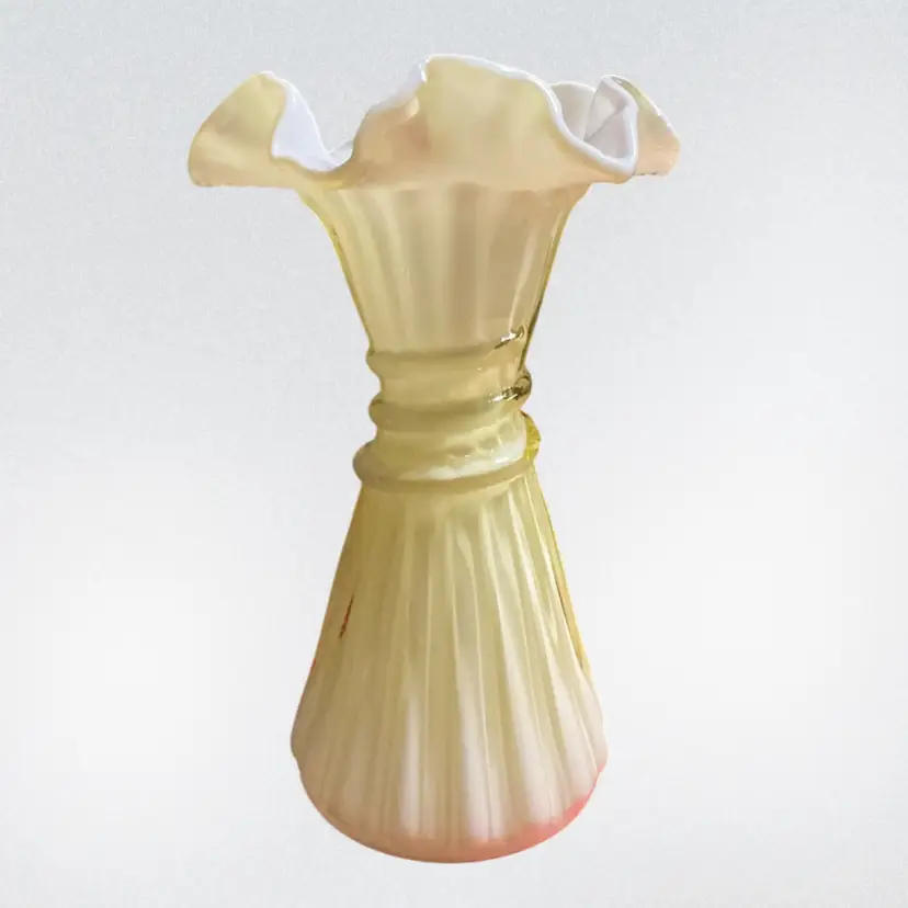 Fenton "Wheat" vase in the Candle Glow (or butterscotch) yellow cased art glass pattern with a white overlay and ruffled rim, typically standing around 7 ¾ inches tall