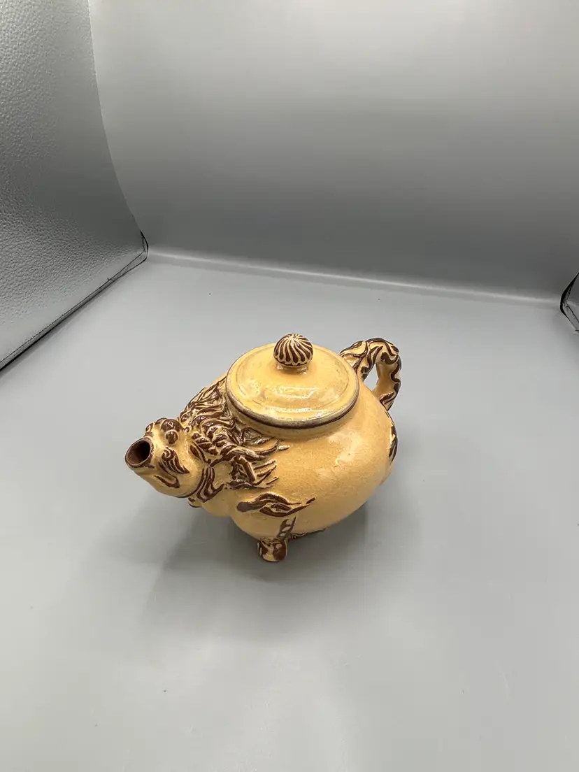 Light Tan ceramic teapot with animal design