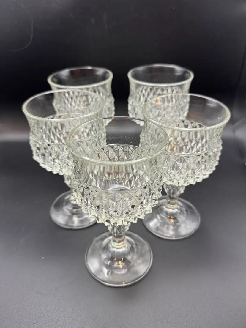 Five vintage Indiana Glass Diamond Point clear goblets; pressed diamond-cut pattern and short pedestal stem.