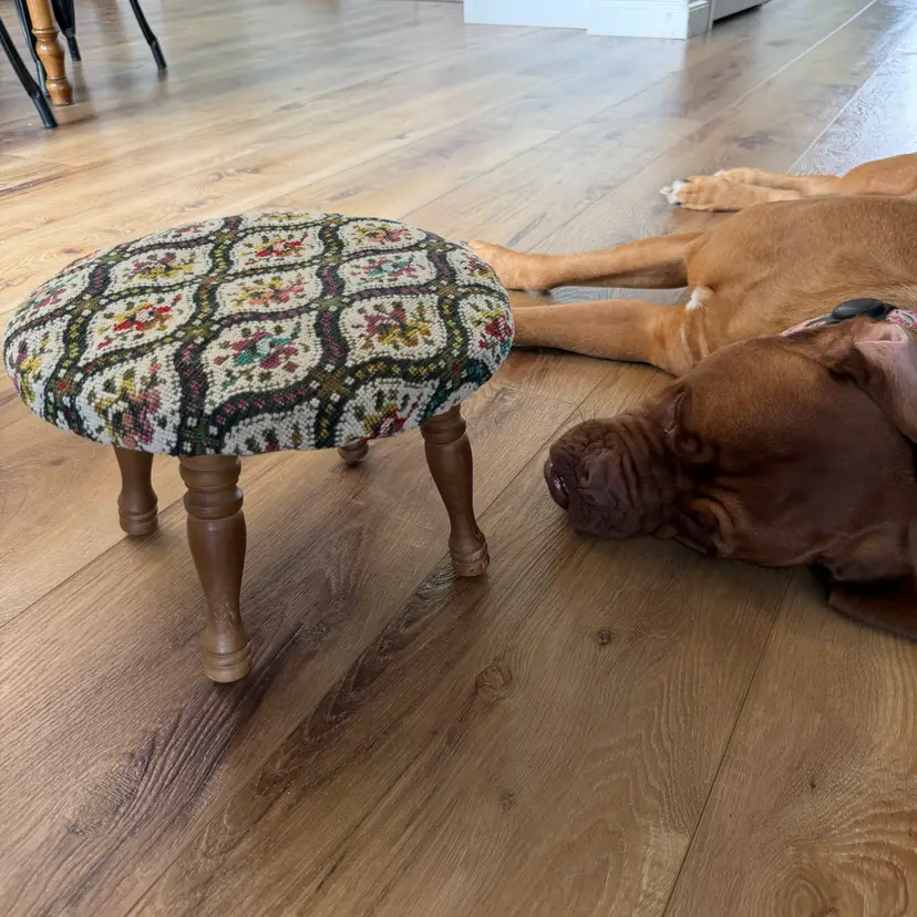 Vintage needlepoint footstool with turned wooden legs and floral tapestry. * Crazy Dog Not Included.