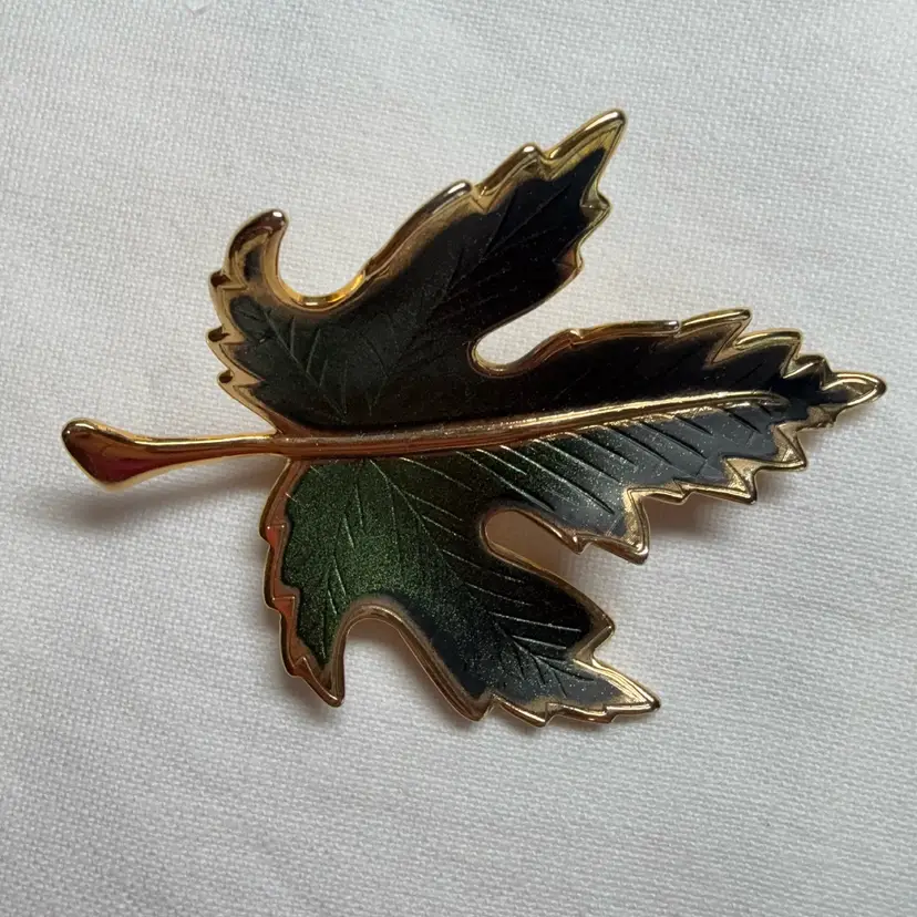 Vintage gold-tone and green enamel maple leaf brooch.
