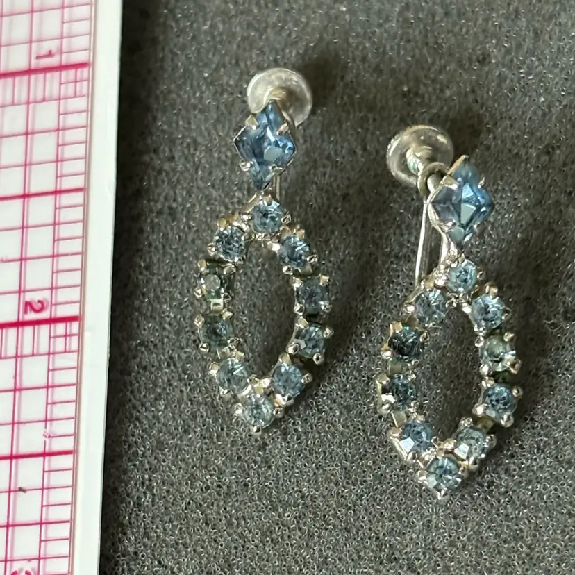 Vintage silver-tone screw-back dangle earrings featuring light blue square and diamond-shaped rhinestones, circa 1940s-1950s.