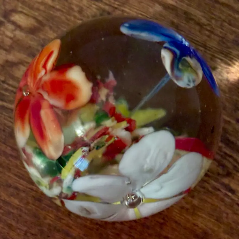 Vintage art glass floral and lampwork paperweight featuring encased glass flowers