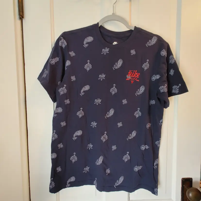 Men's Top- Brand: Nike- The Nike Tee. Size Medium. Blue tee shirt. Material: Unknown. No condition issues.
