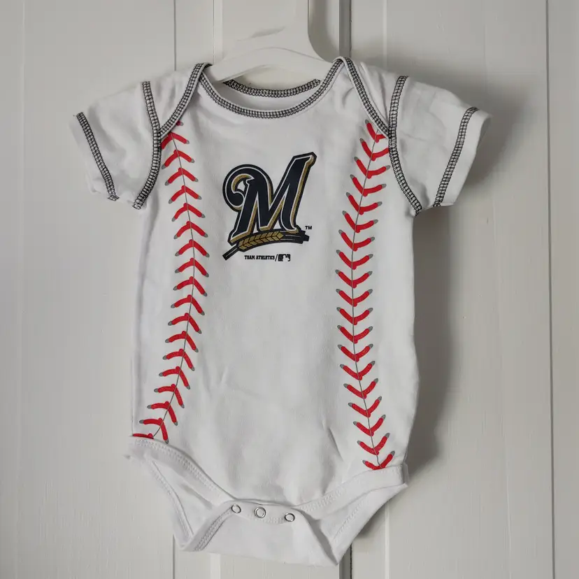 Kids- Brand: Team Athletics- MLB. Size 12 months. NWOT. Milwaukee Brewers baseball Onesie. Material- 100% cotton. No callouts.