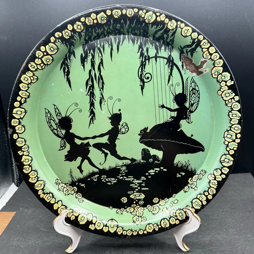#165A Vintage Silhouette Of Dancing Fairies On A Turquoise Blue/Green Tin Tray/Dish
Would Be A Great Display Piece On An Easel Or As An Addition To A Gallery Wall 
Some Pitting Of The Metal In Spots And Wearing Around The Rim And There Is One Large Spot Of Exposed Metal on The Top Right. See Pictures.