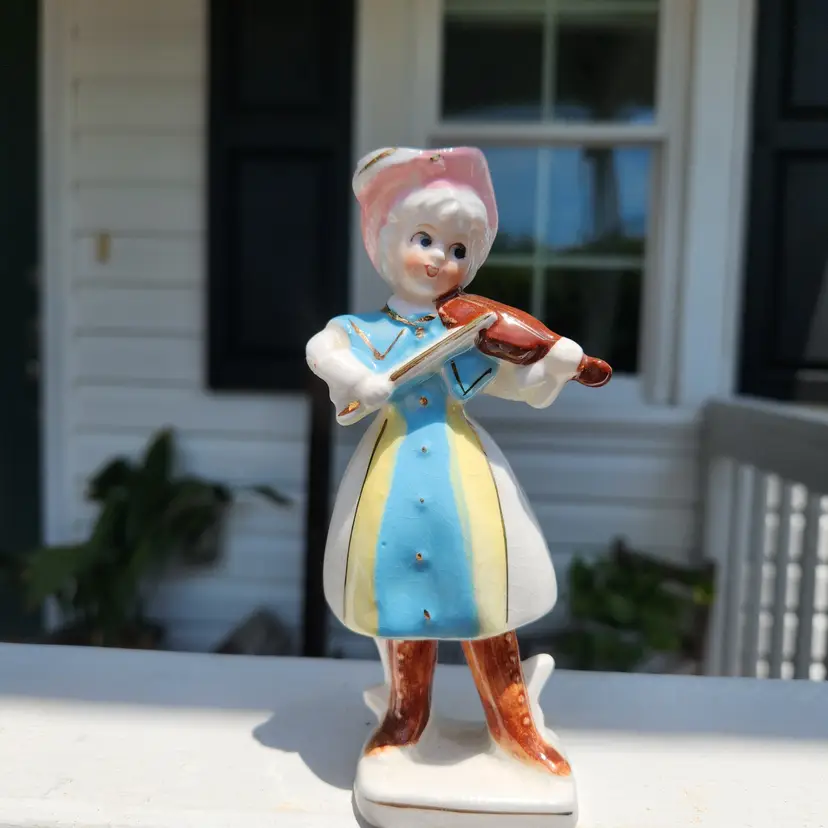 Figurine of Girl-Porcelain-5 1/2"-has small chip on elbow but not sharp