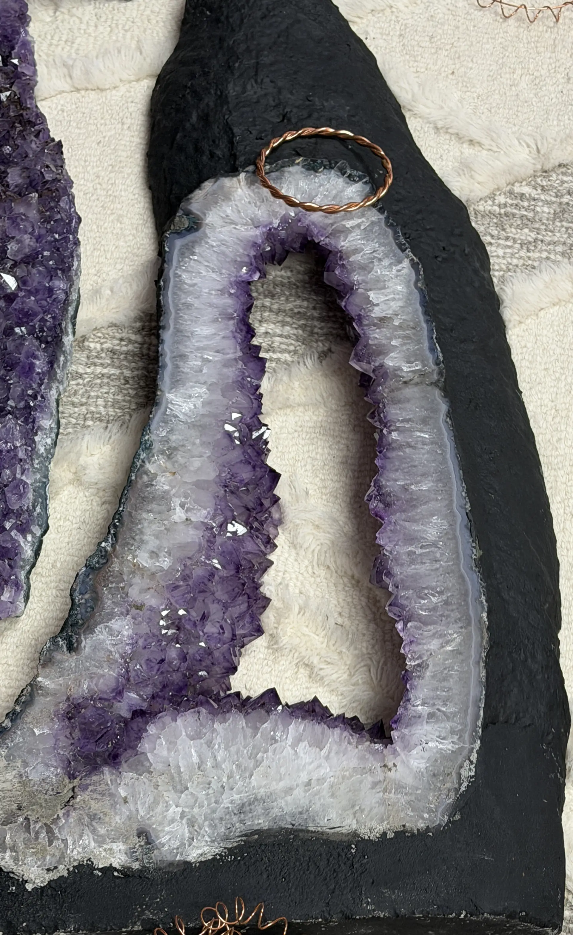 Purple amethyst geode interior with copper coil detail