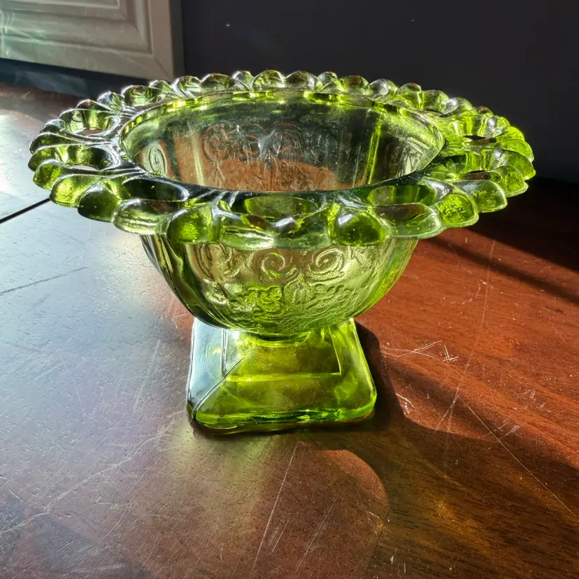 A green depression glass footed candy bowl in the Lorain pattern by Indiana Glass. 4H” x5” W
