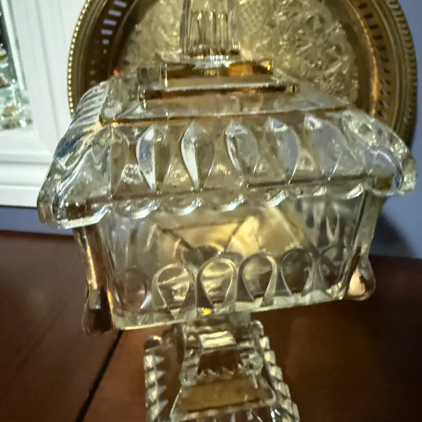This is a mid-20th century clear pressed glass pedestal wedding box base by Jeannette Glass.