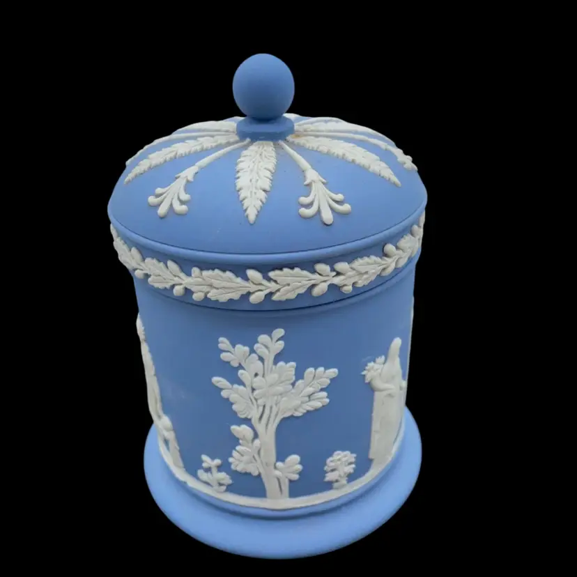 #2712 A blue Wedgwood Jasperware canister with white relief classical figures and lid.