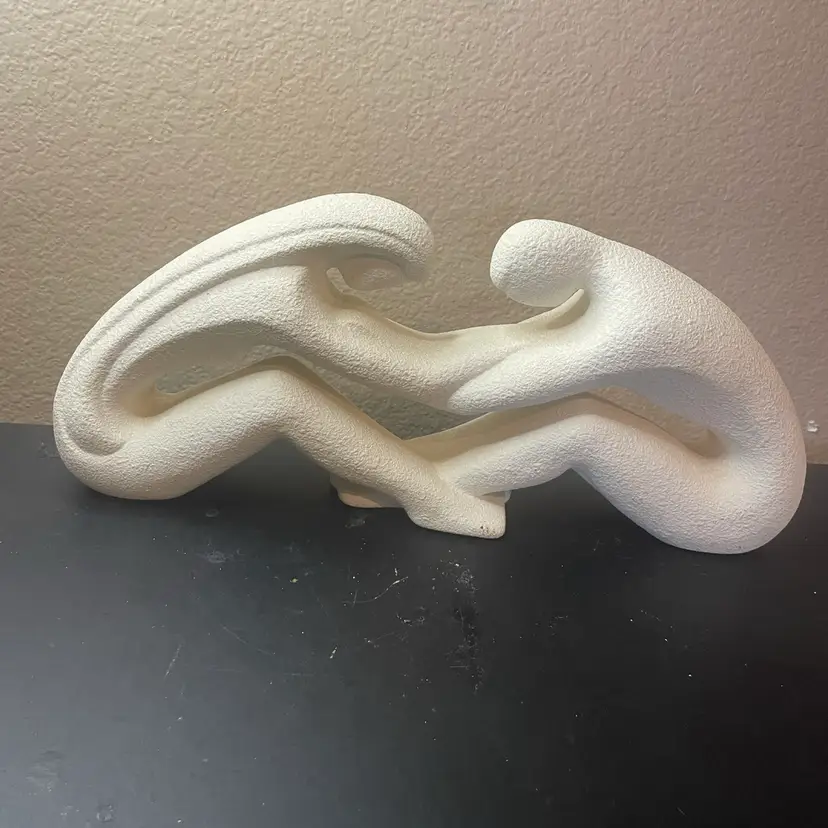 1980 Royal Haeger 15” Couple Reaching Infinity sculpture (Model #322) featuring two intertwined, elongated figures in a matte white sandstone-like textured finish.