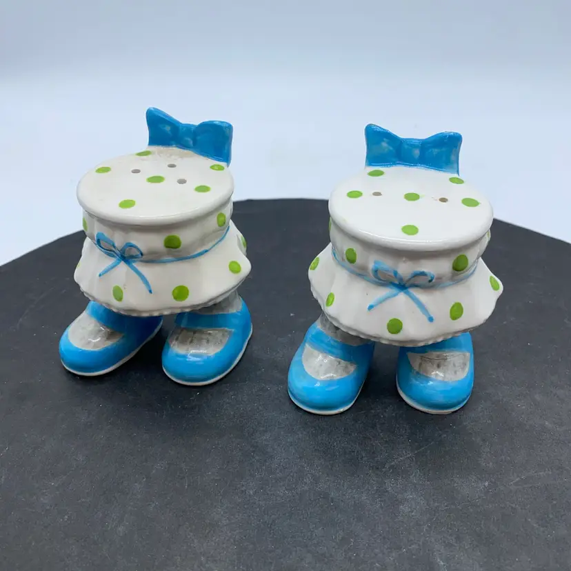 Vintage ceramic salt and pepper shakers with polka dot dresses and blue shoes.