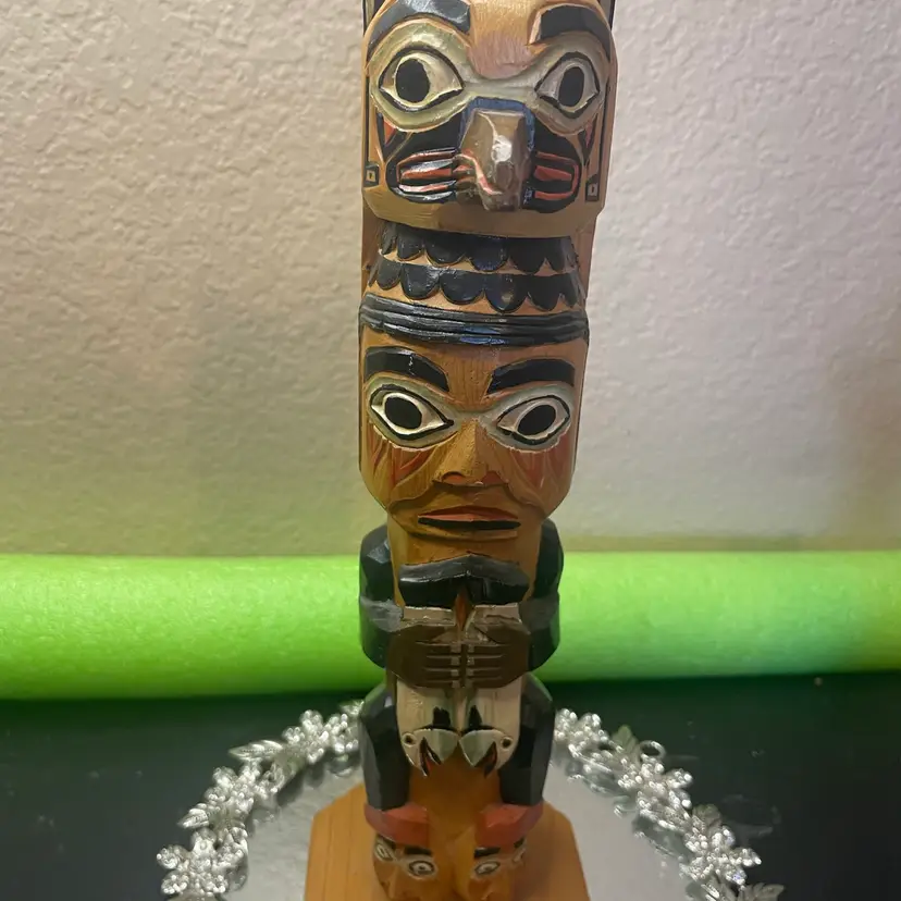 Hand-carved and hand-painted 11” wooden totem pole figurine crafted from Alaskan yellow cedar Signed By artist Patrick Seale