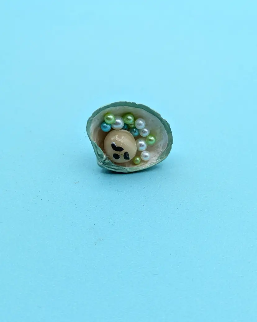 Sleeping Pearl Baby Pin in a Green Iridescent Shell