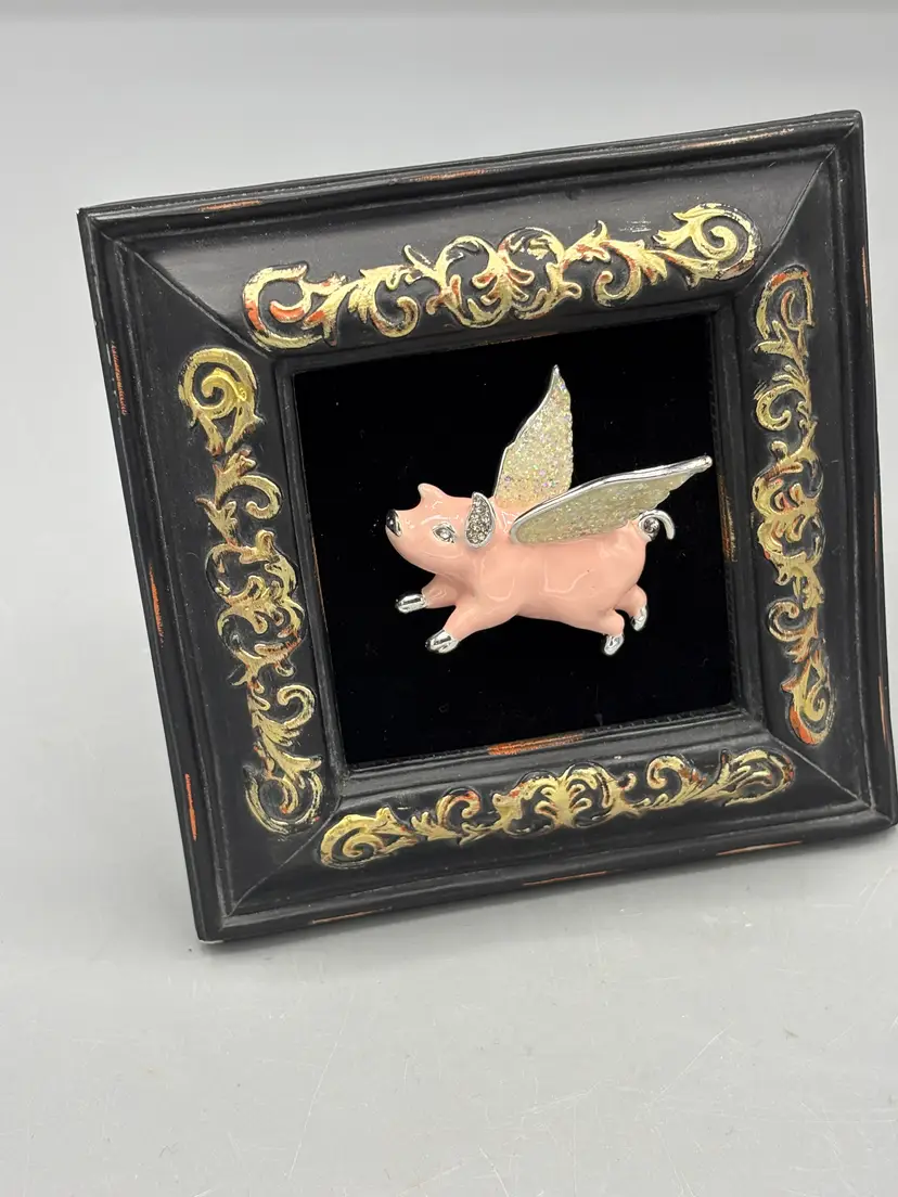 Black frame with pink flying pig