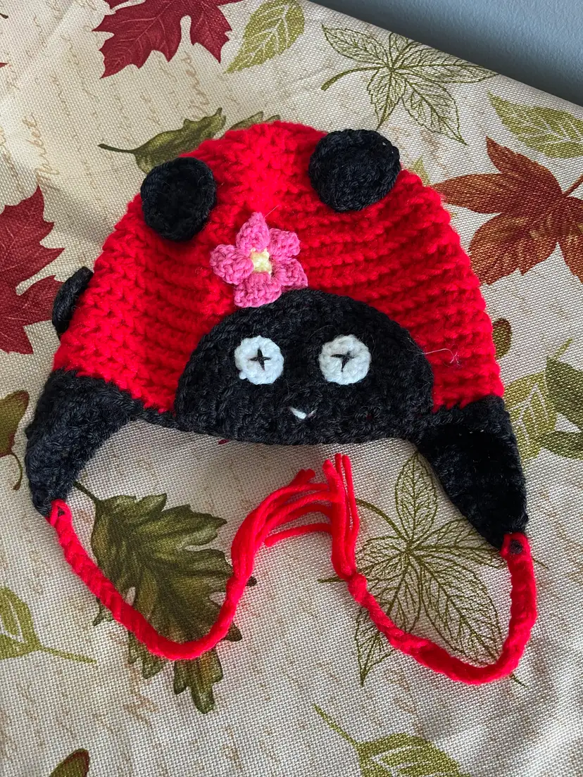 Crocheted Ladybug Hat with Flower Accent