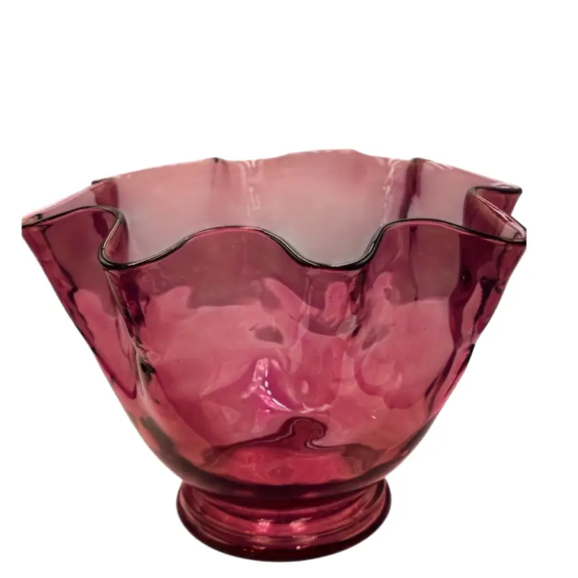 Cranberry glass bowl with a ruffled edge and pedestal base